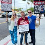 Adam Conover Instagram - Best part of picketing is meeting your heroes. This week I met Dolly at the Pride Picket (@supnebrasska), and Ben Edlund, creator of one of my favorite shows from my childhood. It was an amazing week 5 on the line - can’t wait for next week! Warner Brothers Studios - Burbank, CA