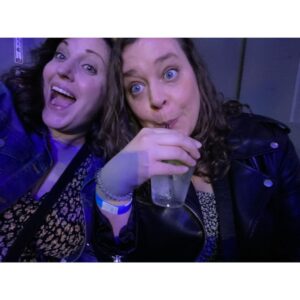 Allison Tolman Instagram - We’re doing it we did it we’re together we’re out! 

*edit for clarification because I’m an idiot: This is my college friend Kate who is visiting from St. Louis. We haven’t seen each other in years. We finally hauled ourselves off the couch and out into public to see @ttfapodcast live. I wrote this caption super fast before turning my phone off for the show. I didn’t mean to accidentally come out on National Coming Out Day, and I can’t wait to tell this story on a podcast. Jesus fuck. 🤦🏻‍♀️ 

** I can promise you if I ever come out in an Instagram post it will be with professionally shot thirst trap photos of me and the super hot masc lesbian or enby of my dreams who has finally rescued me from a lifetime of dating men. ❤️
