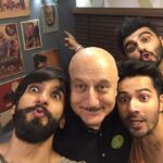 Anupam Kher Instagram – Caption this pic: I don’t know why this pic of #Ranveer #Varun and #Arjun taken few years back reminds me of the film #Padosan. May be the madness created here. Also don’t miss #Arjun ponting to the poster of #DrDang from the movie #Karma! 😂😂🤣🤣❤️ #ActorsLife #Friends #Fun Taj Dubai Hotel