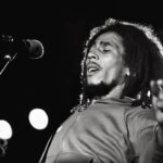 Bob Marley Instagram - “When you think it’s peace and safety, a sudden destruction. Collective security for surety, yeah!” #RatRace #bobmarley 📷 rare pic of Bob live in Cardiff, Wales from 1976, by #AdrianBoot ©️ Fifty-Six Hope Road Music Ltd. Ninian Park