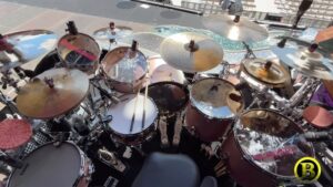 Brian Frasier-Moore Instagram - The #bfmpinkpantherkit is back! #summercarnivaltour2024 Designed by @bfm22 & @antonio_geary 🙏🏾

Brian Frasier-Moore’s Drumkit for Stage A

@pearl_drums Masterworks Series Reference Pure Shells
Finish: Satin Rose Gold

Kick Drums: 24” x 14” & 20” x 14”
Snare Drums: 14” x 6.5” Reference 20 Ply Snare with STL100 Lugs
BFM Signature Snare with STL100 Lugs in Satin Rose Gold
12” x 5” 10 Ply Maple Snare with with Mastercast Hoop

Toms: 10” x 7” Concert Tom with Mastercast Hoop 13” x 7” Rack Tom with Mastercast Hoop
16* x 16” Floor Tom with Mastercast Hoop
18” × 16” Floor Tom with Mastercast Hoop
が”x18”＆6x 21”Rocket Toms with Matching Hardware

Hardware: Pearl Icon Rack (Custom Configuration)
P2050C Pearl Eliminator Redline Pedal (2)
S1030 Pearl Snare Stands (x3)
H2050 Pearl Hi Hal Stand
CH1030C Boomerang Curved Cymbal Arms
D3500BR Pearl Drum Throne with Backrest

@sabiancymbals Configuration:
12” Sabian HHX Evolution Splash
15” Sabian HHX Groove Hats Traditional Finish
18” Sabian AAX Explosion Crash (x2)
19” Sabian Legacy Crash Brilliant Finish
20” Sabian Artisan Crash Brilliant Finish
22” Sabian BFM Signature Ride (Coming Soon)

@evansdrumheads Configuration:
Kick Drums: Evans EMAD 2 Clear
Concert, Rack & Rocket Toms: Evans G2 Clear For To5 elerence Saule: StDry Coated
BFM Signature Snare: Evans Hybrid Coated 12” x 5” Maple Snare: Evans ST Dry Coated

@rolandglobal Electronics:
Roland SPDSX-Pro Sampling Pad
Roland RT30K Acoustic Kick Drum Trigger
Roland RT30H Acoustic Drum Trigger on Snare Drums (×3)

@seelectronics  Microphones

@dauzdrums padsin Pink Panther Pink (x2)

Accessories:
@humesandberg  Custom Enduro Cases
@tunerfishluglocks 
@drumdots Drum Dampeners
@cympad Felts in Pink
@vaterdrumsticks BFM Signature Drumsticks
BFMWORLD custom @lowboybeaters 
@kickblock.drums 
@kellyshuguy 

Custom Printed Graphic Drumheads by @drumstatic

Brian Frasier-Moore’s Drumkit for Stage B

Pearl Drums Masterworks Series

Reference Pure Shells
Finish: Satin Rose Gold
20” x 18” Kick Drum on Legs (x2)
5” x 10” M1050 Snare with Matching Lugs in Satin Rose Gold

Hardware:
Pearl Icon Rack (Custom Configuration)