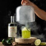 Bryan Cranston Instagram - It’s nearly the weekend, right? I like a bit of spice with my @doshombres margarita. Let me know if you’re brave enough to try... DH Margarita 1.5oz. Dos Hombres Mezcal 3/4oz. Agave Syrup 3/4oz. Lime Juice 3/4oz. Roasted Poblano Puree Pinch of Salt Add all ingredients to a shaker tin filled with ice, shake vigorously, double strain over ice in a rocks glass. Garnish with a lime wheel and *optional smoked rosemary sprig. *Roasted Poblano Puree: High flame on gas stove. Add poblano directly over flame, allow skin to bubble and blacken (2-3 min on each side), flip every few minutes, DO NOT allow to catch fire or turn to white ash, remove charred poblano and place in a small ice bath to cool, remove skin and discard, cut to remove stem, seeds and ribs; add to food processor, pulse until smooth. *Smoked Rosemary: Carefully smoke the end of rosemary sprig with a kitchen torch and blow out after a few seconds for extra essence.