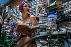 Chelsey Reist Instagram - #tbt to venezia, toiling in the aisles of books stacked from the canals to the ceilings of an eclectic bookstore. what a dream. 

#grandmothersearrings #libreriaacquaalta #venezia #venice #italia #longingtobeback #booklover #travelitalia

my thoughts:
this diamond grit sandpaper grain as i thumb my way through someone else’s refined expressions;⁣
i need the crisp of real pages, i love the smell of prose, closed silent like flattened secrets waiting for me to conjure them to life by mouthing their own little sequenced spells. ⁣