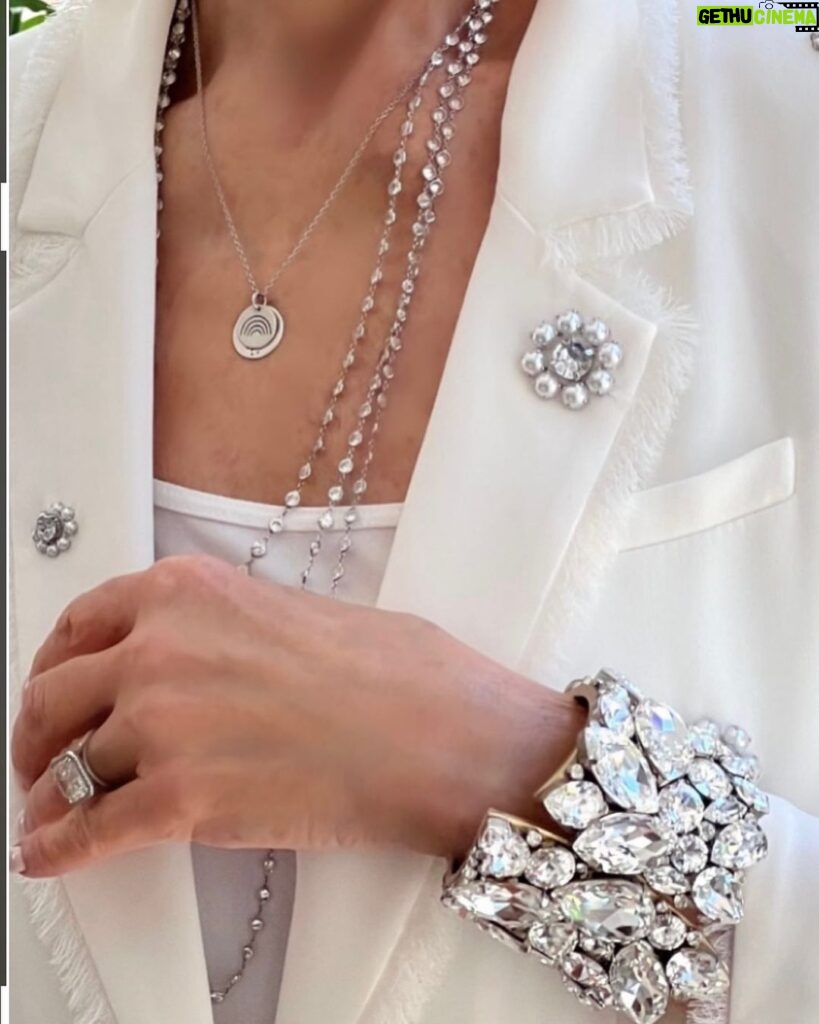 Cristina Ferrare Instagram - I received many inquires about the beautiful suit I wore to the "The Race to Erase MS” event founded by one of the most inspirational women I know @nancydavis! Also, evidently my over the top Swarovski Crystal cuff caught everyone’s eye!! and the tiny medallion I wore around my neck and it’s meaning. The beautiful suit I wore is from, @cinqasept whose founder and CEO is Jane Siskin. We were treated to a sneak peek of their new spectacular collection! People were literally stopping me to tell me how beautiful my suit was! The whole evening was devoted to raising funds to continue finding new drugs and a cure for MS! Thank you Nancy and congratulations on the 30th anniversary of raising millions of dollars to make a difference in people’s lives with MS! The Cuff was made and designed by Tim Hosier. He and his partner@brianthorson own a beautiful home decor store in Palm Springs, @marquettehome. The one that emotionally touches my heart is the little medallion I wear around my neck. Many people asked me the meaning behind it. I have not taken it off ever since my daughter @ariannasalyards_ put it on me. She created the pendant after suffering 3 pregnancy losses. She wanted something tangible to hold as she could only hold her babies in her heart. It is for her a symbol of hope. Part of the proceeds from the sale of the necklace go to continuing the work of advocacy, access to care, education , awareness and community support! If you know of anyone who is going through IVF or infertility issues You can find the necklace @silpadadesigns Thank you Nancy, Jane and Arianna, women making a difference!!❤️