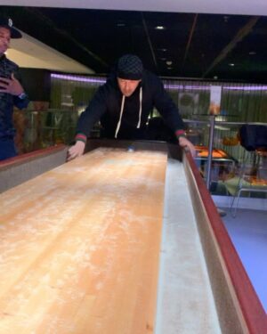 David Yost Instagram - Forever in Our Hearts! Hard to believe it’s already been one year.
These videos are from when @jdfffn , @walterejones & I were in Belgium…just playing shuffleboard. “A little sand for good luck.” Walter was the only one who stayed on the board.