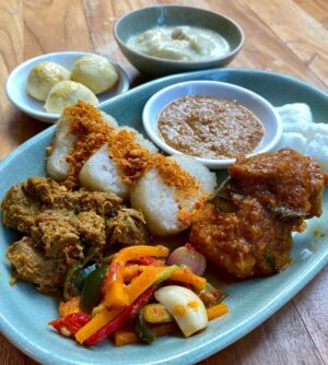 Deanna Yusoff Instagram - Selamat Hari Raya Aidilfitri. Maaf Zahir dan Batin.
Stepped out into the beautiful day after a big brunch (yes cooked this myself) and happy to show off my Baju Raya in this tropical setting.
Missing my friends and family this Raya (again) but grateful for my blessings. Stay safe and let’s continue to be positive. 

#rayaaidilfitri 
#maafzahirbatin 
#bajuraya 
#homecooked 
#lemang
#nasiimpit 
#rendang
#curry
#acar
#peanutsauce 
#serunding
#pineappletarts 
#pengatdurian
#tropical
#brunch
#ifeelpretty 
#staysafe 
#malayfood 
@matasesutera