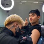 Elijah Canlas Instagram - Remember when you’d always joke about wanting to get a full sleeve of tattoos, JM? Tapos sasakyan ko yung pagbibiro mo kay mom until she gets pissed and tells us to not go home if we do push through with it. Guess what? Kuya Jerom and I just got tatted today. We even brought Iya with us. Mom’s fine with it now. She actually wants to get one herself. Even Dad wants to get tatted now. Pero siyempre tungkol sa’yo ang design. Your favorite thumbs up pose with your name enlaced on it designed by ate Zia. Our cousins also got the same design marked on them. Matching kami lahat. I want you with me forever and always. We all do. I can’t believe it hasn’t even been a month. Thank you for being my strength. I miss you so much it hurts. Pero kaya ito ni kuya. Kaya namin ito. We love you more than anything, JM! Habang buhay. Habambuhay.