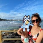 Ellie Taylor Instagram - Took a break Down Under with my little Bluey. A beaut of a trip full of sun, sea, delicious egg & bacon rolls, excellent margs and some bloody bonza Sheilas/Bruces. However I can’t pretend I don’t have concerns about something I witnessed first hand over there which I found incredibly worrying. An issue which is blighting the gorgeous homeland of my husband. And that is what I can only describe as a MULLET EPIDEMIC. They are everywhere. EVERYWHERE. I even saw a few toddler aged kids with them. No irony there. Just some little boys eating sand on the beach whose parents CHOSE for them to look like 1989 Andre Agassi. 🤯