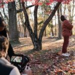 Florence Pugh Instagram - 150 added theatres this weekend!! So excited to announce. If you go and check out our movie this weekend please let us know what you think! @agoodpersonmov Fun fact about these shots outside, we were in the middle of setting up and shooting THAT scene at the end with Nathan and Allison sat opposite each other on a round table (no spoilers don’t worry) and one of the cameras wouldn’t work. I can’t seem to remember why but it was full on ‘oh shit oh no we don’t have much time oh fuck’ energy going on. And Zach got his Red Komodo camera out and said let’s just shoot some content outside in the beautiful red leaves and we did. Whilst the other camera was being tinkered with. For me, I’ve always loved the thrill of having to turn the day around and change everything ‘right now’. It happens a lot on smaller movies due to not wanting to waste any of the shoot day because of budget, everyone just having to turn the day on it’s head instantly in that moment because you don’t have time to dawdle. That energy of, if you don’t move now we will lose this day and this time so let’s just shoot something. At the beginning of my career I learnt only on tiny baby iddy indie movies, that just HAD to have that energy throughout or else you came out with nothing. I love it. I love that magic on a film set. Everyone moving fast, everyone dedicated, moving lights and sandbags and booms and radio’s last minute getting everything out of shot. It weirdly, nearly always captures something pure magic. This shot was magic!