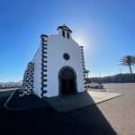 Hugh Wallace Instagram – Today we visited Ermita de Los Dolores, (Our lady of Sorrows) a modest 18th-century church with a rich history.

The church has a single nave built in white stonework with black volcanic details. Its façade is crowned by a double gap belfry that serves as a bell tower, with a semi-circular arch across its entrance together with a small translucent oculus. All of this is presided over by a Catholic cross. Its most prominent element is its half-orange dome with a skylight in the centre. 
When I’m on holidays I love to visit places of interest, any other suggestions? 
#lanzarote #architecture Lanzarote, Canary Islands