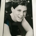 John Gallagher Jr. Instagram - I’m taking a cue from the GOAT @msmelanielynskey here. As you can see from this questionable old headshot (why the sleeveless tee?!) I’ve been working as an actor for a while now. I’m not exactly sure when I got my @sagaftra card but I was still a teenager so it must’ve been around the time this picture was taken. I’ve been extremely fortunate to work fairly steadily throughout my 23 years in this volatile and ever evolving industry. Work has been waining for me in the last few years though as it has been for many performers. A combination of factors including the pandemic, slowing momentum, plain old aging, changing trends, a pickiness about what roles I accept that I’ve been privileged enough to try and maintain and now this necessary but disruptive reckoning with the forces and factors of corporate greed that have slowly been eroding protections for the workers over the last decade. With so much at stake, not just for me but the entire profession, I feel the vital need to stand strong and proud in solidarity during this strike with my fellow actors/writers/creators and human beings who only wish to be paid fairly for their work and not be replaced by AI. It’s not an unreasonable ask. As the late, great Richard Manuel once sung, “I’m a union man now, all the way.” ✊🏻