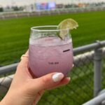 Julie Stewart-Binks Instagram - Thanks @woodbinetb for inviting my family to the first “King’s Plate” since 1951. The last few years, we’ve been watching from home and getting creative 🐴 But today was so special to witness it in person! Huge thank you to @daviddunkleyhat for the beautiful fascinator to complete my look - this dress was my grandma’s, the lovely Jean Binks ❤️ #kingsplate #woodbineracetrack #andtheyreoff #paramountprince #horseracing #canadiantriplecrown #queensplate Woodbine Racetrack