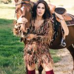 Kerri Kasem Instagram - This dress was one of my favorites from the @fashionmagazinenyc shoot! Shot by the one and only @arezoojalali_photography! ❤️ @tessasilagy - horse Thank you to the team! @jbeauty_xoxo - make-up @sky_is_dlimit - stylist @pr_solo - stylehouse @ellazahlan - feather dress @friesiansm - horse coordinator 🐴 #featherdress #Western #KneehighBoots #horsesofinstagram