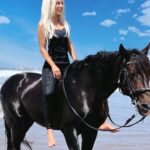 Kerri Kasem Instagram - Just hanging out with Brego on a Moroccan beach! He’s such a good boy! Right after this, I took his bridle off and we went galloping down the beach, which you can see if you scroll down my profile. If you want to have the same riding experience, go to @my_cavago and look for @yassine_cavalier! #Morocco #Beach #Horse #Stallion #Blonde
