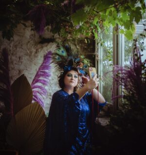 Kiri Pritchard-McLean Instagram - A little outtake from my Peacock photo shoot that shows me being very vain, but also being sat on a wobbly stool in my potting shed, freezing my tits off. 

This is a good time to say a huge thanks to everyone who's bought tickets to my tour already. You're so kind and I'm going to make sure we have the best time on all these dates. I'm still pinching myself that a have a few sold out dates already and a handful of others close behind. 
📸 @_drewforsyth 
💄 @alexogdenclark 
👗 @fumbalinas 
🦚 @philjperry