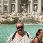 Magda Szubanski Instagram – #MagsTravelTips Compare the pair. I recommend seeing the #trevifountain during a thunderstorm in a flouro pink plastic poncho. You get the joint (almost) to yourself. Most tourists are pussies who don’t like to get wet. That said, it took 3 days for my runners to dry. And I did get a touch of foot rot. The other, sun shiny way is also good. But I couldn’t do the traditional “three coins in a fountain” coz, ya know, inflation #roma #travelblogger #FatLadyTravels ❤️🇮🇹🪙⛲️😘 
To those suggesting newspaper in my shoes …all very well…except newspapers don’t exist anymore. And you can’t dry your shoes with digital media. Tho there is a lot of hot air 💨 🔥 Fontana Di Trevi-Roma
