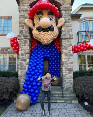 Meaghan B. Murphy Instagram - Mamma Mia! My fully charged friend ⚡️Danielle (p. 177 of YFCL) + @dreamfactoryballoons 🎈have outdone themselves once again to raise $ and awareness for @crohnscolitisfoundation_nj 

For the 10th year, friends and neighbors are invited to tour the balloon fantasy land, spin the wheel, win a prize & make a donation for the Crohn's and Colitus Foundation. Danielle started the tradition as a way of coping after their 9-year-old was diagnosed with the disease. I celebrate + admire her for channeling pain into purpose. It feels good to do good! Click the donation button to give back.

And in case you were wondering, my last-minute costume = French Kiss! Get it: Beret + Kiss concert tee!

#balloonart #balloons #halloween #crohnsandcolitis
#bestfieldnj #kiss #mariobrothers