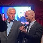 Mo Collins Instagram - I was so amped up about meeting this hero last night that I accidentally grabbed a Spanish version of his book. 😂 This man understands the dangers and importance of the phrase “boots on the ground” when it comes to defending our democracy. @gonell111 did exactly that on January 6 at the capitol. Met him at the launch party for @nrjmediagroup , whom are all primed and ready to bring great projects to light!! Congratulations to this electric bunch!! #j6 #sgtgonell #nrjmediagroup #contentcreator
