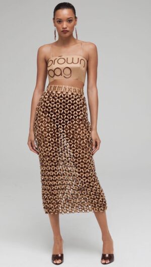Natalia Fedner Instagram - How did I make the honeycomb paper chainmail skirt for @bloomingdales Big Brown Bag anniversary celebration? All the secrets are revealed in this video. The process starts by cutting the BBBs into 8.5 x 11” sheets, ironing them flat (yes, flashbacks to pressing paper patterns out at Parsons were had), then cutting the sheets into thousands of small strips using a hand held paper cutter (that I may have found tossed out on a street corner by my West Hollywood apartment…), and finally taping them together with little double sided tabs to create a honeycomb like pattern. I used this technique to create the skirt for the project, finishing it off with a Bloomingdales waistband (sourced from the side of the bag). The paper skirt is delicate, but because of the technique I developed for the project, it actually stretches quite a bit and allows a full range of movement! 

#bigbrownbag #paperart #paper #papercrafts #bloomingdales #kraftpaper #garlands #diy #paperdress