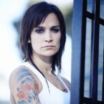 Nicole da Silva Instagram - What does this image of Franky have to do with #afghanistan🇦🇫 ? There’s news to come. In the meantime, head to the link in my bio to find out how you can help Afghan women and girls 💥 @unwomenaust 📸 @benkingphotographer Image Description: Nicole da Silva as Franky Doyle stands in front of prison bars with short cropped hair, rats tail and arm tattoo. Naarm