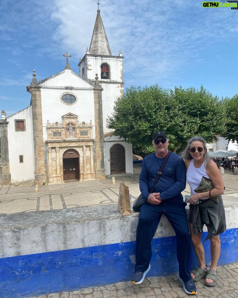 Patricia Heaton Instagram - On the way back to Lisbon from Nazaré we stopped in Óbidos, one of the most beautifully preserved villages I’ve ever visited. Beautiful cobbled streets lined with historic buildings drenched in flowers. Obidos Portugal