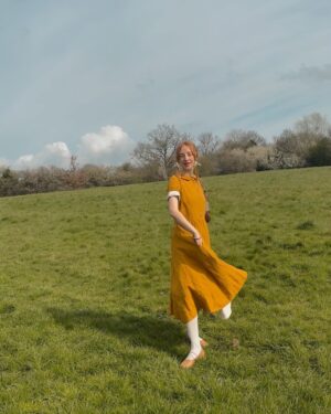 Rebecca Flint Instagram - Spring’s first light filling the pages with shimmering delight ☀️ 

Feeling very little women, in my @sondeflor classic short sleeve dress in marigold 🌻 
 
made from 100% locally sourced Lithuanian linen and free shipping right now 😊

#thisjaneaustenlife #ofwhimsicalmoments #fairycore #cottagefairy #asecondofwhimsey #wherefairiesdwell #theheartofslowliving #softcore #coquetteaesthetic #parisiennegirl #thatvelvetfeeling #dreaminginpictures #amomentofwonder #ofquietmoments #whimsicalwonderfulwild #meadowcore #gardencore #warmcore #vintagecore #aseasonalshift #embracingtheseasons #quietchaotics #naturecore #lafemmeparisienne #monlook #onparledemode #romanticstyle #softgirlaesthetic #fashionhistory #springoutfitideas