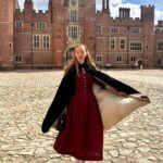 Rebecca Flint Instagram – if you can’t wear a cape in hampton court palace i’m not sure where you can 🌹?

I have always wanted to see this incredible tudor palace for myself and I was so excited to have the chance!

they had live cooking demonstrations inside the original kitchens, and we saw so many amazing tapestries and paintings… incredible day to visit!

the puff headband trend always reminds me of the French Hood so I had to wear this army green one, along with this spectacular velvet and silk cape picked up from @classiccarbootsale in the spring! My dress is vintage from Japan, and my bag is @aspinaloflondon. The shoes are @empressaustralia 🔍

Not forgetting my B necklace as an homage to Anne 🅱️❤️ Hampton Court Palace