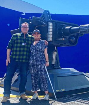Russell T Davies Instagram - Me & director Chanya Button and a Great Big Gun, in a heatwave. Stand by for Chanya’s masterpiece, as the Toymaker returns and the Earth slides into hell. THE GIGGLE: Who’s laughing now? BBC ONE, Dec 9, 6.30pm 😱🤡💀 @bbcone @bbciplayer @disneyplus @nph @chanyabutton