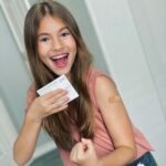 Shaylee Mansfield Instagram - I have a very serious needle phobia... When I was little, I was ill and had seizures. That came with so many tests and shots. But this is bigger than me. It took a sweet nurse, stuffed elephant, and even an order of fries to brave the first vaccine shot! #halfwaythere #covidvacccine #whew #onedownonetogo #pfizer Austin, Texas
