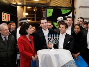 Sierra Boggess Instagram - The cast of @harmonyanewmusical celebrating Hanukkah outside the Barrymore Theatre with a menorah lighting, blessings and songs 🕎💙

Photos: Paul Aphisit
