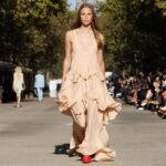 Stella McCartney Instagram - STELLA’S SUSTAINABLE MARKET: Light and loose. The ruffles of stage looks, reinterpreted as tiered organic chiffon dresses, draped shirting, elongated waistcoats. Watch the #StellaSummer24 runway show at stellamccartney.com. Credits Wearable art by @AndrewLoganSculptor, exclusively for Stella McCartney #StellaMcCartney #ParisFashionWeek #PFW #StellasSustainableMarket Marché Saxe-Breteuil