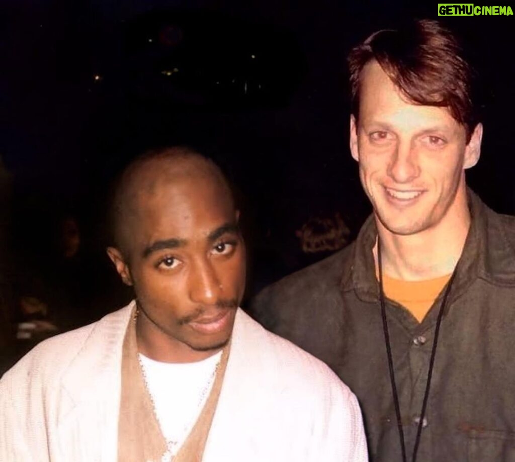 Tony Hawk Instagram - My missing photo with Tupac: I attended the American Music Awards in 1991 because my sister was there performing with Michael Bolton. While backstage, I saw Tupac standing alone and I recognized him from Digital Underground (go listen to “Same Song” for context). His first album had not dropped yet, and nobody else seemed to notice him. I took a picture of him and [Riley’s mom] Cindy, and I thought she took one of him and me. This was in the era of point-and-shoot film cameras so results were unreliable. Unfortunately I never found the photo once the roll was developed. But thanks to modern technology and maestro digital artist @_vemix_ , the image has materialized. And for the record: he was effusive and gracious during our brief encounter, more so than anyone else we met or bothered for pictures that night. Edit: this might have been 1994 based on the AMA nominees that year. I’m so old that specific years get fuzzy. But the story remains the same. Shrine Auditorium & Expo Hall