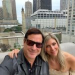 Bob Saget Instagram - My beautiful wife @eattravelrock (her legal name) and me having such a nice time as always on the rooftop @thepeninsulachi @zbarchicago - I’d like to thank the Peninsula for their always awesome service— and hairspray for allowing me to be photographed in the Windy City. @choosechicago The Peninsula Chicago