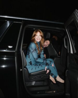 Bryce Dallas Howard Instagram - Many things to toast this weekend 🥂 A @universalpictures family reunion for the ages, 3 weeks until the @argyllemovie premiere, a fresh haircut from @misterjasonlow, and most importantly, my hot date @stealthgabel 💋

📸: @andiejjane 

[ID: Debuting a middle part after many, many years, BDH wears her hair down and a fitted long-sleeve dress with a moss & black dye print. As she gets ready for the Universal Pictures party, she takes photos around the house and with the ever-handsome Seth Gabel.]