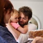 Bryce Dallas Howard Instagram - This beautiful baby girl turns 11 today. She is brilliant and full of joy and I am completely obsessed with her. Love you Bumble ❤️ Happy Birthday⁣ ⁣ [ID: BDH holds out a chocolate chip cookie cake for little Beatrice who is wrapped in Seth Gabel’s arms. BDH and Seth smile with all the love in the world at their daughter.]