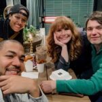 Bryce Dallas Howard Instagram - Burgers and fries, the perfect candlelight dinner 😋⁣ ⁣ [ID: Clockwise from left: Alano, Nia, Bryce, and Seth are all smiles (and silly faces), celebrating the weekend with a group dinner outside on a patio.]