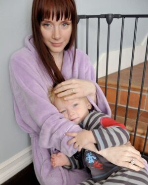 Bryce Dallas Howard Instagram - This baby boy turns 16 today and I LOVE HIM SO MUCH! Happy Birthday Theo!!!! Mumsie and Whoopsie love you ❤️⁣
⁣
[ID 1: At the kitchen table, young Theo sits in BDH’s lap. They both smile softly as BDH gently rests her head on top of Theo’s.]⁣
⁣
[ID 2: Sitting on the floor in comfy pajamas, BDH cradles a young Theo in her arms. BDH wears a fluffy light purple robe and Theo wears matching striped shirt and bottoms.]