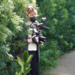 Bryce Dallas Howard Instagram - They say a director must become one with their environment 😉🌳 I’m filming my second documentary feature for @disneyplus and am very excited for you see what’s on the other side of the camera! ⁣ ⁣ For all the film techies out there, this is @canonusa’s EOS C300 — I was so lucky to be one of the first directors to test this camera back in 2011 for my short film "When You Find Me" 🚀 I absolutely love how intuitive it is to operate. 100% recommended. ⁣ ⁣ [ID: BDH in a grey cardigan, white v-neck, and black leggings becoming one with tall hedges, holding a Canon camera. 📸: @fullyjacked]
