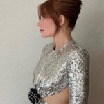 Bryce Dallas Howard Instagram - A magical night at the BAFTAs in London 🎭🪩⁣ ⁣ Hair: @cwoodhair ⁣ Makeup: @kaymontano⁣ Styled by Publicist Extraordinaire: @alex.schack 📸 1+6: @cwoodhair⁣ 📸 2-5: @gettyentertainment @BAFTA ⁣ #EEBAFTAs⁣ ⁣ [ID: Arriving on the red carpet with her hair in a relaxed up-do, BDH wears a silver sequined long-sleeve dress from @newarrivals.co with a cut-out around the waist ending with a black rose. Paired with the dress are a pair of black @maisonvalentino platform heels and a silver beaded bracelet & ring from @bulgari.]