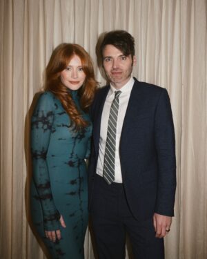 Bryce Dallas Howard Instagram - Many things to toast this weekend 🥂 A @universalpictures family reunion for the ages, 3 weeks until the @argyllemovie premiere, a fresh haircut from @misterjasonlow, and most importantly, my hot date @stealthgabel 💋

📸: @andiejjane 

[ID: Debuting a middle part after many, many years, BDH wears her hair down and a fitted long-sleeve dress with a moss & black dye print. As she gets ready for the Universal Pictures party, she takes photos around the house and with the ever-handsome Seth Gabel.]