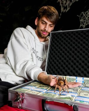 Chandler Hallow Instagram - “Would you sit in snakes for $10,000?”