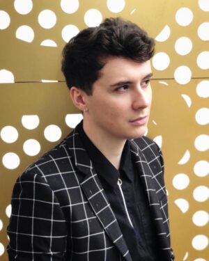 Daniel Howell Instagram - smart casual but try to make it edgy and stand in the rain in front of an office full of people watching you do a photo shoot