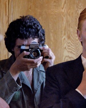 David Bowie Instagram - Not much evidence of a mirror in this first shot from 1975 of Bowie as Thomas Jerome Newton, until you look at those famous eyes.

All is revealed in the uncropped image as Geoff MacCormack is seen taking the shot in David’s changing room on the set of The Man Who Fell To Earth. 

Have you read Geoff’s book DAVID BOWIE: ROCK 'N' ROLL WITH ME?

It’s a touching account of a lifelong friendship, peppered with Geoff’s extraordinary shots of David at work, rest and play: https://bit.ly/RockNRollWithMeBook (Linktree in bio)

#BowieReflections