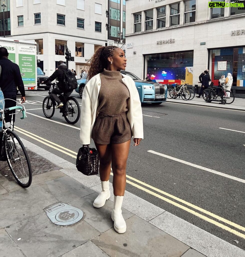 Jackie Aina Instagram - where we going? 💭 🗺️ (swipe to the end to find out) coat: #dior cardigan: #dissh shorts: #jacquemus boots: Dior handbag: #bottega earrings: Dior #londonstreetstyle #londonfashion Hermes New Bond Street