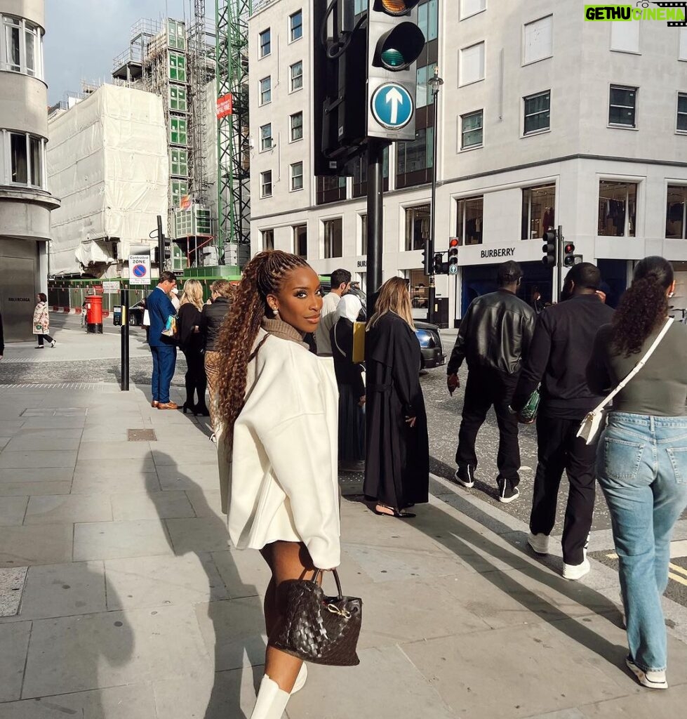 Jackie Aina Instagram - where we going? 💭 🗺️ (swipe to the end to find out) coat: #dior cardigan: #dissh shorts: #jacquemus boots: Dior handbag: #bottega earrings: Dior #londonstreetstyle #londonfashion Hermes New Bond Street