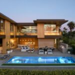 Jason Oppenheim Instagram - Just Listed in Manhattan Beach - 1001 1st St. - $29,900,000 6 Beds / 9 Baths / 9,479 Sq. Ft. The most impressive and high-quality Contemporary estate ever built in Manhattan Beach, featuring panoramic ocean views from every room. After a laborious multi-year build, this approximately 9,500 sq. ft. showstopper seamlessly fuses glass, cedar, and concrete into a triumphant architectural tour de force with a sense of permanence and grandeur. Integral to the structure and aesthetic of the home, the scalloped concrete walls seen on the exterior and interior walls resemble an undulating wave-like texture accomplished by custom milled formwork which complement the surrounding Pacific landscape. Custom cedar clads the remaining walls and ceilings, bringing warmth and visual impact throughout the sleek space. Double-height ceilings and oversized automated Otiima pocketing doors and windows create a sense of expansion within, as the home seamlessly unfolds into an extensive beautifully landscaped outdoor terrace and pool/spa perfect for California living. An additional shaded patio with fireplace is created by the deep cedar overhangs from the upper floor and the roof. Generously nestled on an extra-wide corner lot, the home is replete with 6 bedrooms plus an additional office/nursery, 9 bathrooms, home theater, game room, wine cellar, wet bar, and gym, with architecture by Laney LA. Additional amenities include 48 solar panels with Tesla Powerwalls, elevator, 14 zone A/C technology platform system, Control4 home automation, and 3-car garage with additional driveway parking. An exceptionally rare opportunity to own a meticulously crafted beach estate with soul and sophistication. Manhattan Beach, California