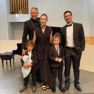 Jeff Goldblum Instagram - A heroic and brilliant mom, wonderful teacher Kevin Anto, and the whole family in a glorious recital (Charlie’s very first performance), all of us on a whirlwind creative adventure. Beyond my wildest dreams, I’m more in love every day!!! @emiliegoldblum 👸🏻👨‍👩‍👦‍👦🎼🎹🌪🎨🗺🌌🪐💗