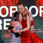 Jenna Davis Instagram – Wow we did it 🥹 Last night @hollywoodcreativealliance #AstraAwards left us speechless. Wouldn’t have wanted to spend it with anyone else but my favs @violetmcgraw and @madeleinemcgraw ❤️ So insanely proud and happy our movie @meetm3gan won this evening! Thank you @blumhouse @universalpictures @atomicmonster for believing in us and this film! 

🎀: @hairbybradleyleake 
✨: @styledbylmc 
👗: @lethanhhoa_official 
👠: @betseyjohnson 
👛: @jeffreylevinson 
💍: @ettika @heymaeve