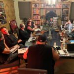 Joe Manganiello Instagram - Got the band back together after three years of remote play and no play… WAR OF DRAGONS Episode 73 kicked off with a food truck and a two hour recap from the very first adventure five years ago, all the way through to the present. The Sandal of Gygax made its appearance as it settled into its new home for the next calendar year at The E. Gary Gygax Memorial Dungeon in Beverly Park next to a set of Gary’s dice gifted to me by his son Luke for my 42nd birthday a few years back. Vince spearheaded a surprise for me, a framed piece of art by Max Dunbar that was used to craft the Wizkids miniatures sets, including all of the characters in the group but this time, with a looming Tiamat above. So f-ing cool… It was a blast seeing everyone in person! Can’t wait for the next session.