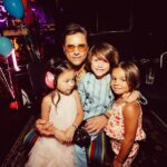John Stamos Instagram - I thank my beautiful wife who knows how to throw a party - Fake Beatles, @raintribute (the best Beatles band ever!) Real Beach Boys, @mikeloveofficial @jamieleecurtis handing out @stamos bracelets, @glenpowell riding some big cow-like animal, all my friends, family, (party crashers) it was a 60’s party that was better than the actual 60’s ! 📸 @micalaaustin @canyonagoura THANK YOU!